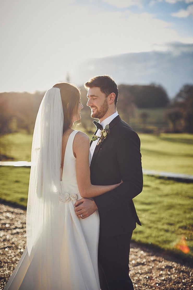 bride and groom in golden hour sunlight at small winter wedding at Rockbeare manor in Devon